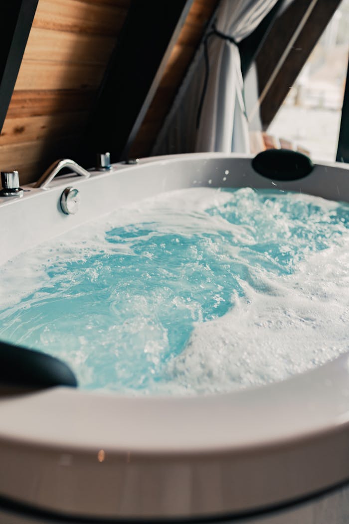 Relax in a modern indoor whirlpool tub with soothing bubbles and wood accents.